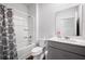 Bright bathroom featuring a shower-tub combo with decorative curtain and a modern vanity with storage at 314 Bear Paw Ln, Summerville, SC 29486
