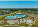 Overhead view of a community pool with various activity areas, a playground, and ample parking, surrounded by residential homes at 314 Bear Paw Ln, Summerville, SC 29486