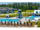 Aerial view of a community pool showcasing multiple pools, a slide, and various amenities amidst a backdrop of homes at 314 Bear Paw Ln, Summerville, SC 29486
