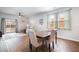 Bright dining room with a dark wood table, four chairs, and sliding glass doors to the backyard at 314 Bear Paw Ln, Summerville, SC 29486