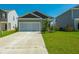 Inviting one-story home with a long driveway, attached garage and green lawn at 314 Bear Paw Ln, Summerville, SC 29486