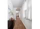 Bright hallway featuring wood floors, a small cabinet, and view into adjacent rooms at 314 Bear Paw Ln, Summerville, SC 29486