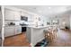 Bright, open kitchen features granite countertops, stainless steel appliances, and an island with bar seating at 314 Bear Paw Ln, Summerville, SC 29486