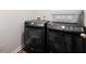 Modern laundry area with front loading washer and dryer units and a storage basket at 314 Bear Paw Ln, Summerville, SC 29486