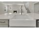 This bright kitchen features a farmhouse sink, stainless faucet, and an open living space at 318 O'Malley Dr, Summerville, SC 29483