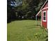 Expansive backyard featuring green grass and a red storage shed at 32 Rosedale Dr, Charleston, SC 29407