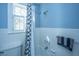 Blue bathroom features tiled bath with shower head and window at 32 Rosedale Dr, Charleston, SC 29407