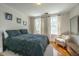 Cozy bedroom filled with light, complete with hardwood floors and a comfortable full-sized bed at 32 Rosedale Dr, Charleston, SC 29407