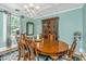 Elegant dining room with a wooden table, chandelier, and bright natural light, perfect for Gathering meals and entertaining at 32 Rosedale Dr, Charleston, SC 29407