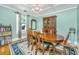 Elegant dining room with a wooden table, chandelier, and bright natural light, perfect for Gathering meals and entertaining at 32 Rosedale Dr, Charleston, SC 29407
