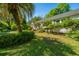 Well-maintained single-story home with a lush green lawn, shrubbery and mature palm tree at 32 Rosedale Dr, Charleston, SC 29407