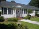 Charming single-story home with landscaped front yard and inviting entrance, featuring classic design and manicured lawn at 32 Rosedale Dr, Charleston, SC 29407