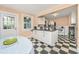 Eat-in kitchen featuring checkered floors, white cabinets, and natural light from windows and door at 32 Rosedale Dr, Charleston, SC 29407