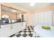 Bright kitchen boasts ample storage with white cabinets, checkered floors, and stainless appliances at 32 Rosedale Dr, Charleston, SC 29407