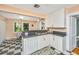 Spacious kitchen featuring white cabinetry, stainless steel sink, and checkered flooring at 32 Rosedale Dr, Charleston, SC 29407