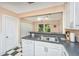 Well-lit kitchen features white cabinets, laminate countertop, and checkered tile flooring at 32 Rosedale Dr, Charleston, SC 29407
