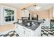 Charming kitchen with black and white checkered floors, white cabinets, and stainless steel appliances at 32 Rosedale Dr, Charleston, SC 29407