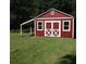 Charming red storage shed with white trim, providing extra storage space at 32 Rosedale Dr, Charleston, SC 29407