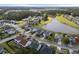 Aerial view showcasing a residential neighborhood with homes nestled around a picturesque lake at 321 Sanctuary Park Dr, Summerville, SC 29486