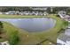 Scenic view of a large pond surrounded by grassy banks in a residential area at 321 Sanctuary Park Dr, Summerville, SC 29486