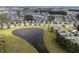 Wide aerial shot of homes nestled around a serene lake, showcasing the community and natural beauty at 321 Sanctuary Park Dr, Summerville, SC 29486