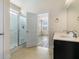 Bright bathroom featuring double sinks, glass enclosed shower, and an open doorway to the bedroom at 321 Sanctuary Park Dr, Summerville, SC 29486