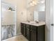 Bright bathroom featuring double sinks, a large mirror, and dark cabinets at 321 Sanctuary Park Dr, Summerville, SC 29486