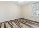 Bedroom featuring plank floors, white trim, and a large window with shutters at 321 Sanctuary Park Dr, Summerville, SC 29486