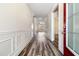 Entry hallway featuring decorative wainscotting, luxury vinyl flooring, and neutral paint at 321 Sanctuary Park Dr, Summerville, SC 29486