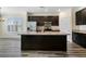 Kitchen featuring dark cabinets, large island, stainless steel appliances, and natural light at 321 Sanctuary Park Dr, Summerville, SC 29486