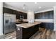 Spacious kitchen with dark cabinets, stainless steel appliances and a large kitchen island at 321 Sanctuary Park Dr, Summerville, SC 29486