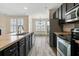 Kitchen featuring an island, stainless steel appliances, and eat-in nook with many windows at 321 Sanctuary Park Dr, Summerville, SC 29486