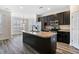 Kitchen with dark cabinets, large island, stainless steel appliances, and natural light at 321 Sanctuary Park Dr, Summerville, SC 29486
