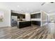 Open-concept kitchen featuring dark cabinets, stainless appliances, and a large island with sink at 321 Sanctuary Park Dr, Summerville, SC 29486
