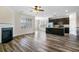 Bright living room with fireplace, wood floors, and a view of the kitchen and dining area at 321 Sanctuary Park Dr, Summerville, SC 29486