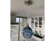 Modern kitchen features a unique blue glass pendant light, bright white cabinetry, and stainless steel accents at 330 Concord St # 11B, Charleston, SC 29401