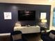 Sophisticated living room with stylish decor, dark blue accent wall, and modern furniture at 330 Concord St # 11B, Charleston, SC 29401