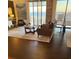 Open living room features floor to ceiling windows, stylish furnishings, and beautiful hardwood floors at 330 Concord St # 11B, Charleston, SC 29401