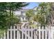 Serene backyard featuring a white picket fence, leading to a stone patio, surrounded by lush greenery at 3372 Billings St, Mount Pleasant, SC 29466