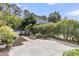 Expansive backyard with a stone patio, mature trees, landscaping, and a white picket fence at 3372 Billings St, Mount Pleasant, SC 29466