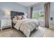 Cozy bedroom featuring a large window, plush bed, stylish nightstands, and elegant decor at 3372 Billings St, Mount Pleasant, SC 29466