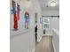 Bright hallway with hardwood floors, natural light, barn door, and colorful dog artwork at 3372 Billings St, Mount Pleasant, SC 29466
