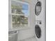 Bright laundry room with a stacked washer and dryer next to a window with natural light at 3372 Billings St, Mount Pleasant, SC 29466