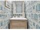 Stylish powder room with beach-themed wallpaper, a wooden vanity, and modern fixtures at 3372 Billings St, Mount Pleasant, SC 29466