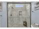 Modern shower with gray tile, built-in shelves, and a small window for natural light at 3372 Billings St, Mount Pleasant, SC 29466