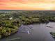 Aerial view of the home near marsh with private dock, and surrounded by lush trees at 3610 Legareville Rd, Johns Island, SC 29455