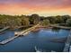 Expansive waterfront property with a private dock, lush trees, and a beautiful sunset view at 3610 Legareville Rd, Johns Island, SC 29455