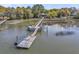 Waterfront home featuring a private boat dock with chairs and kayaks perfect for leisure and relaxation at 3610 Legareville Rd, Johns Island, SC 29455