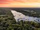 Stunning aerial view of the property showcasing waterfront access, lush greenery, and serene surroundings at 3610 Legareville Rd, Johns Island, SC 29455