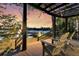 Evening view of deck with seating, overlooking dock and waterfront at 3610 Legareville Rd, Johns Island, SC 29455